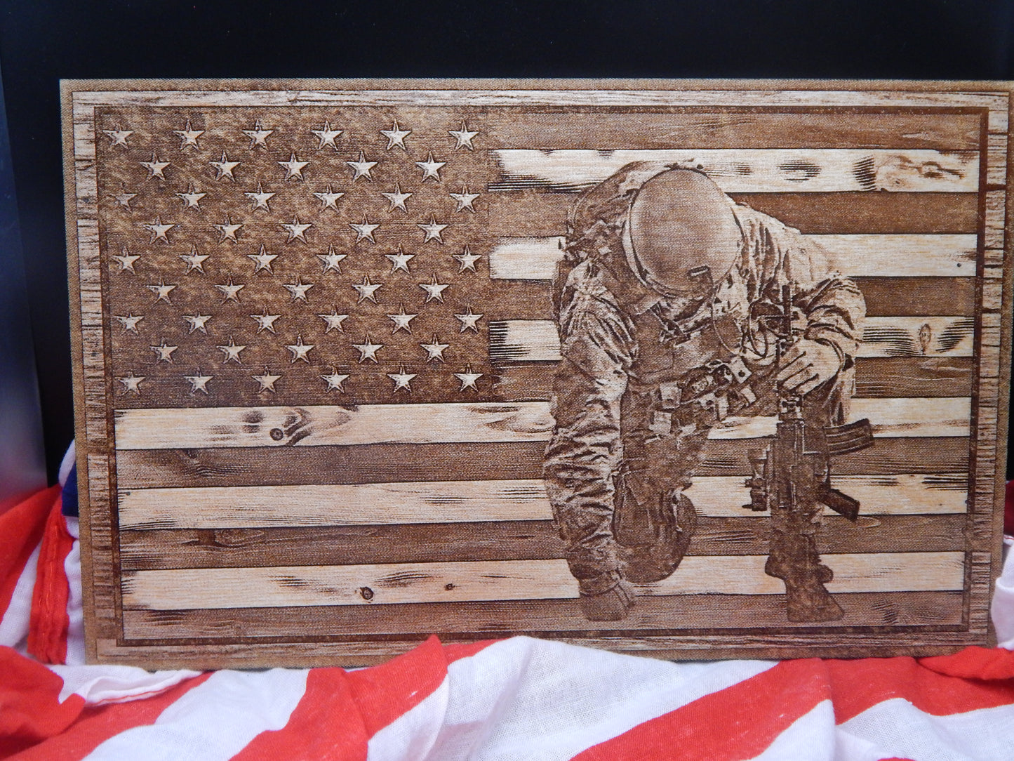 Soldier Kneeling in front of American Flag Sign